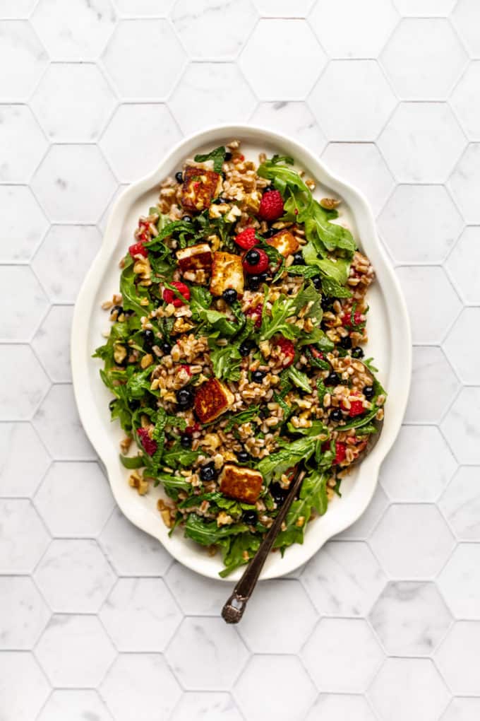 Farro and halloumi salad with berries on a serving tray