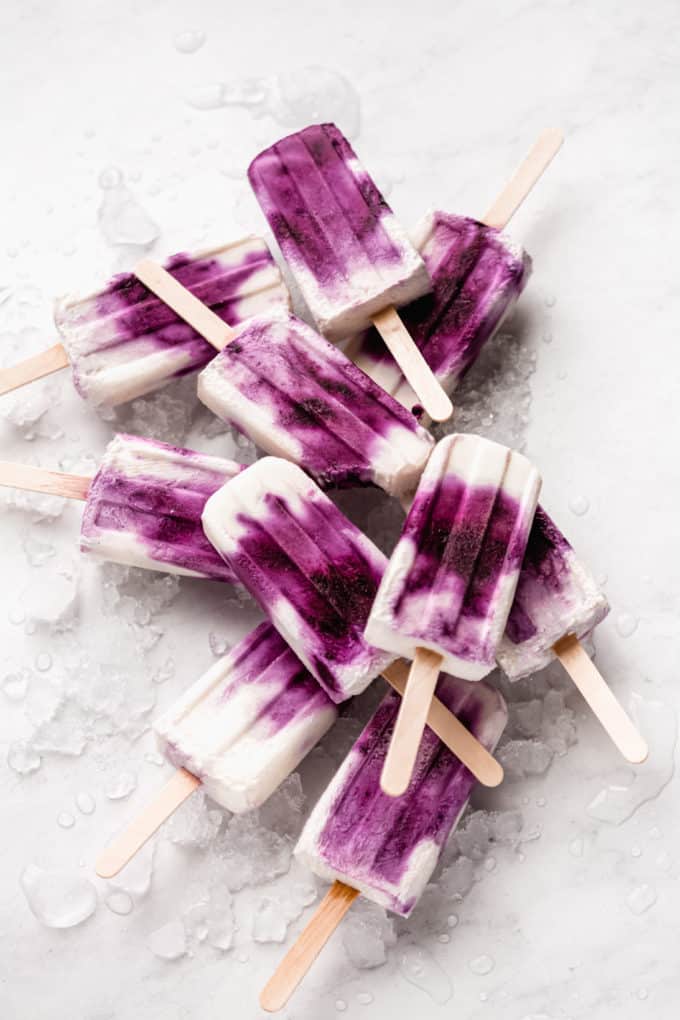 a stack of blueberry greek yogurt popsicles