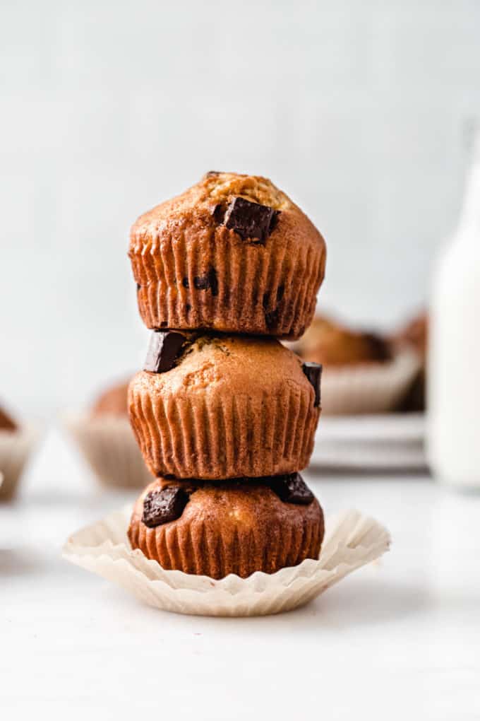 thee banana muffins with chocolate chunks stacked on top of each other