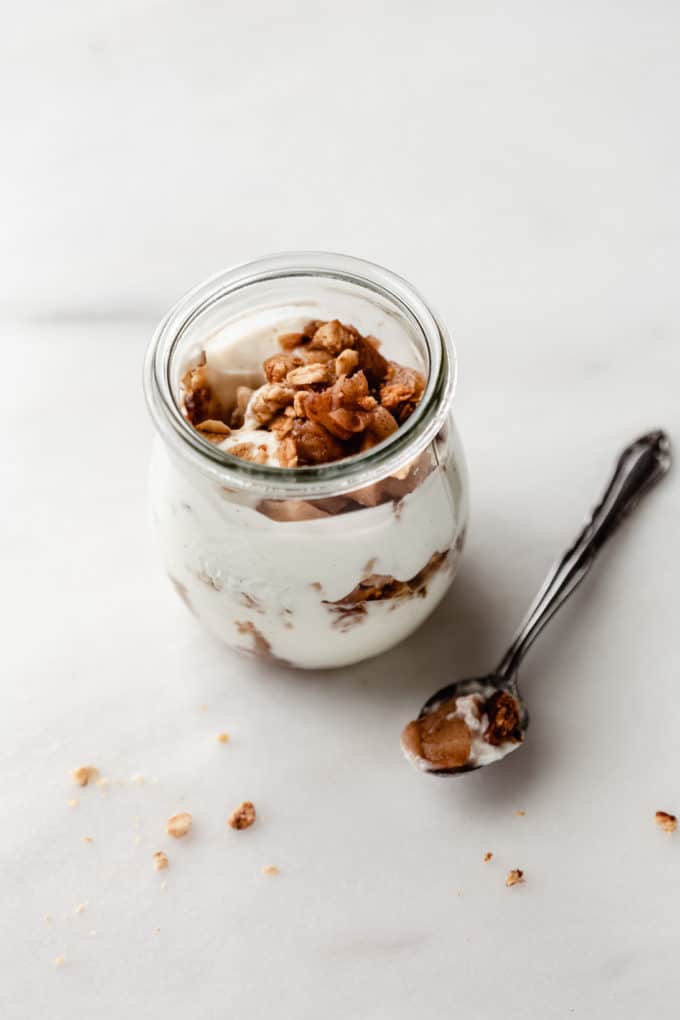 a jar of apple pie parfait with a spoon on the side