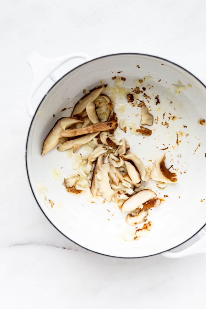 a white pot with mushrooms in it