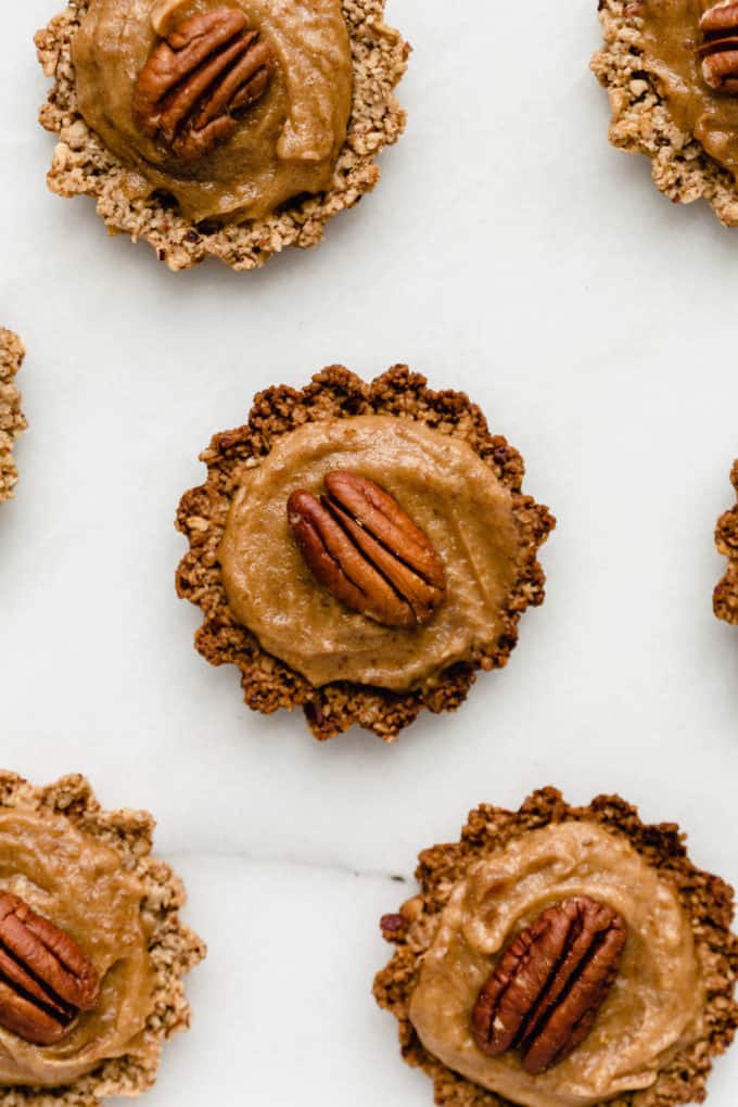 mini pecan pie topped with date caramel and a pecan