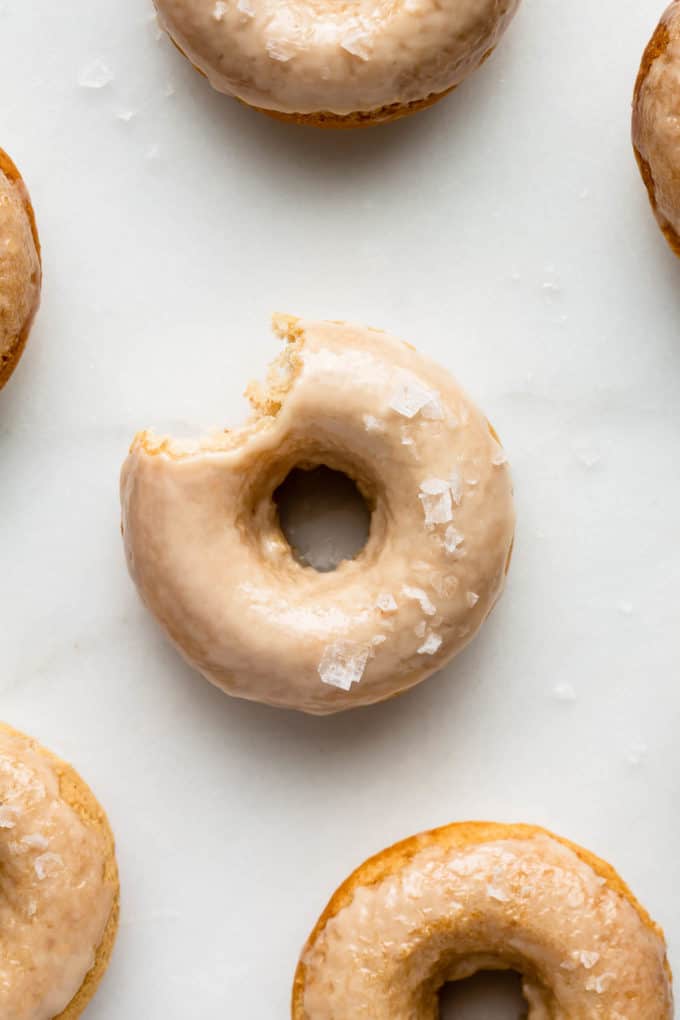 Maple donuts on a marble board topped with sea salt