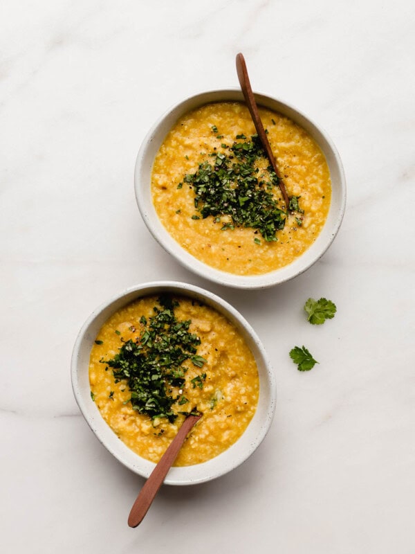 two bowls of aryuvedic khichdi topped with cilantro