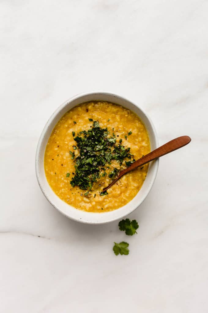 A bowl of Indian split mung beans and rice topped with cilantro