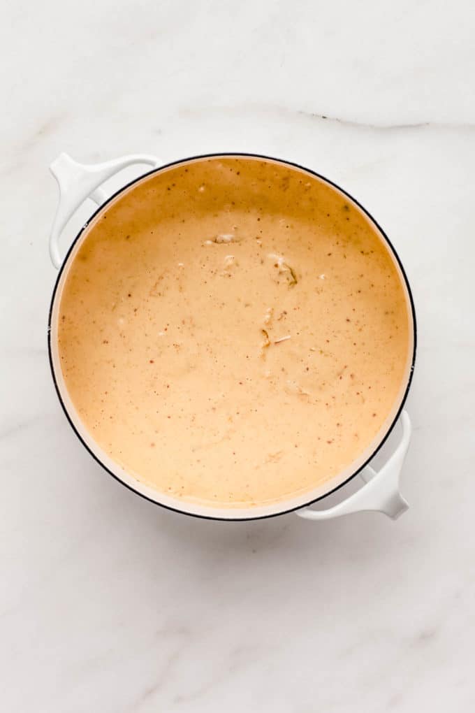 A white pot with vegan kimchi cheese sauce in it