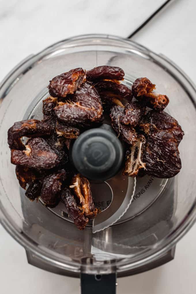 A food processor with medjool dates in it