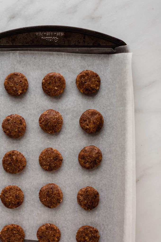 A baking sheet with pecan patties on it