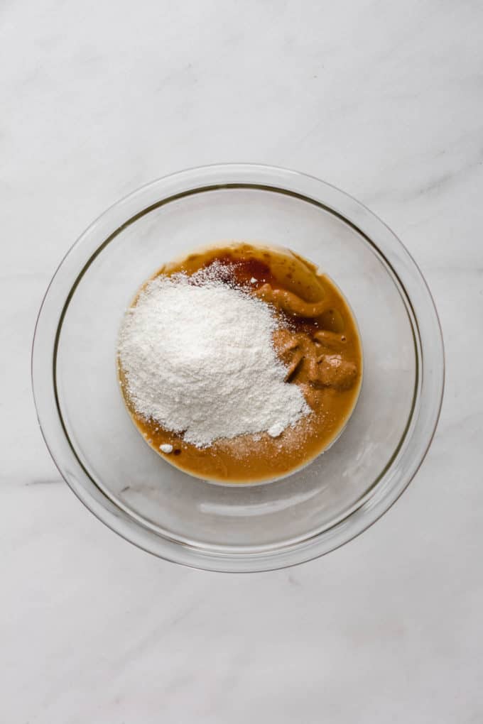 peanut butter and coconut flour in a clear mixing bowl