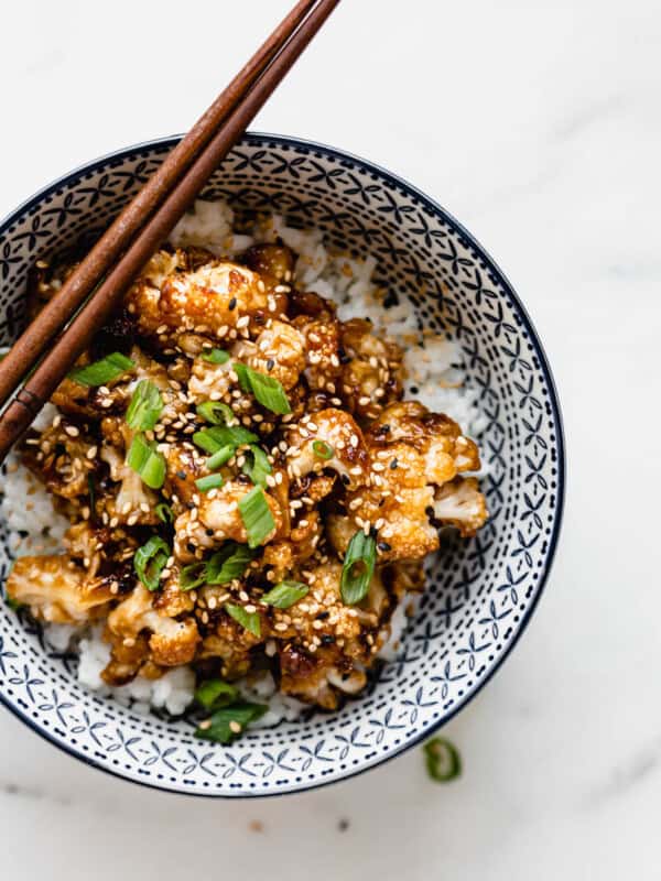 kung pao cauliflower topped with green onions and sesame seeds