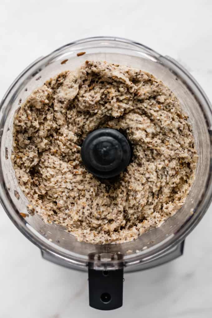 a food processor with blended buckwheat groats and chia seeds in it
