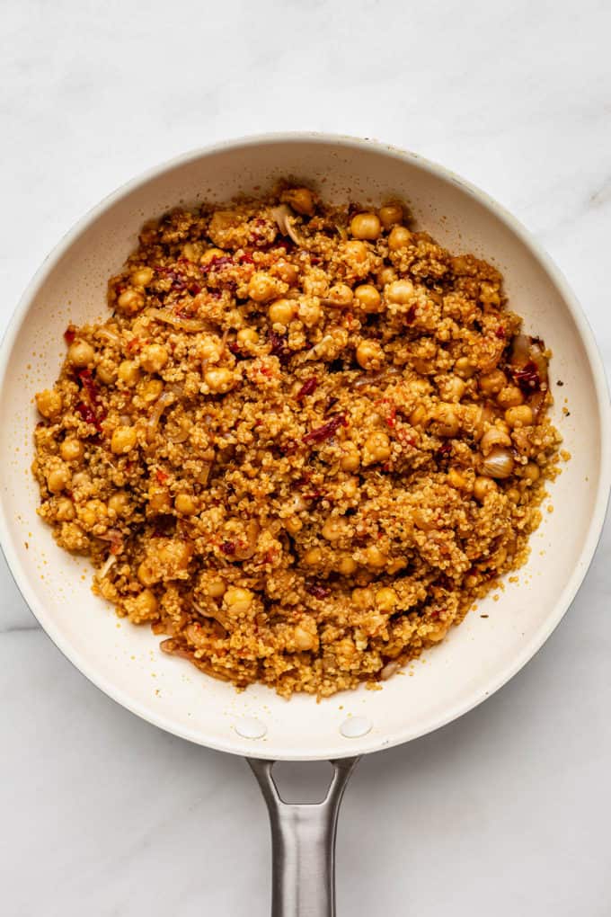 A white pan with sun-dried tomato quinoa in it