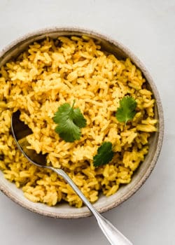 A bowl of turmeric rice topped with cilantro