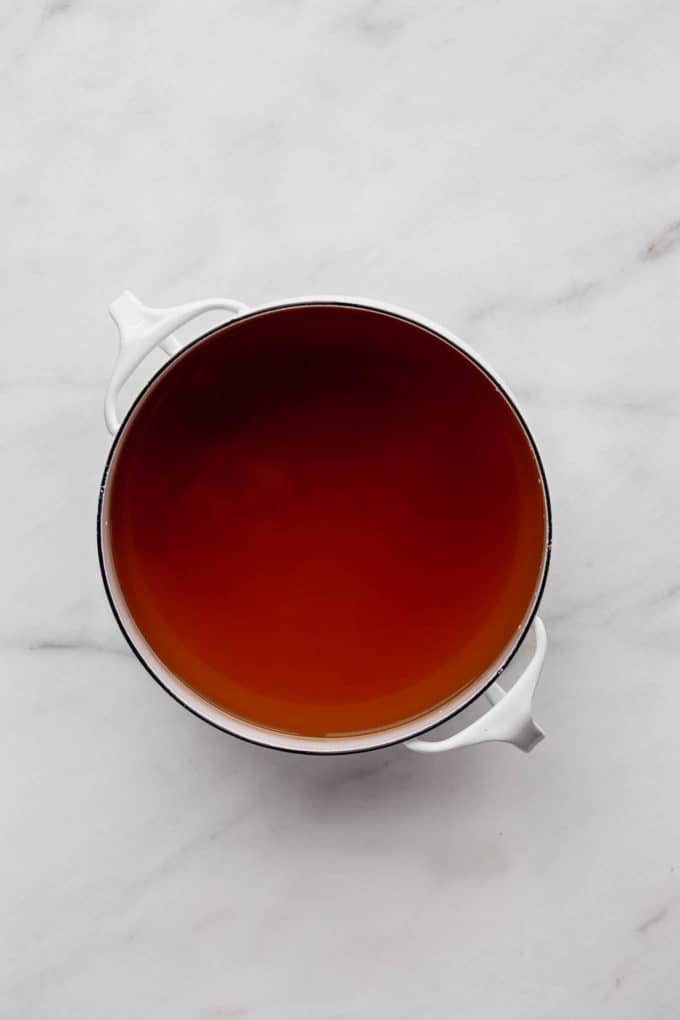 Pho broth in a white pot