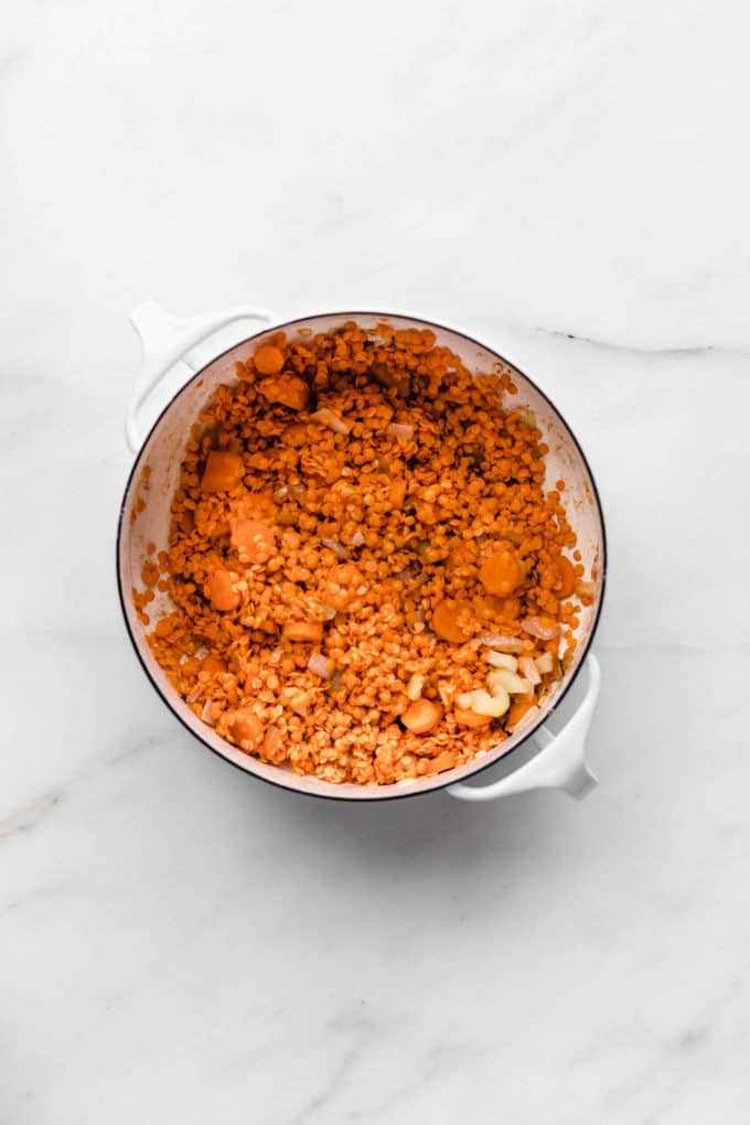 red lentils and carrots in a white pot