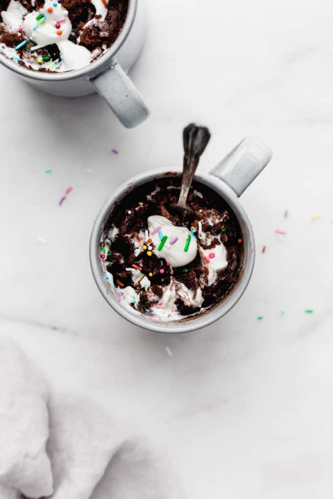 chocolate mug cake in a grey mug with a spoon in it