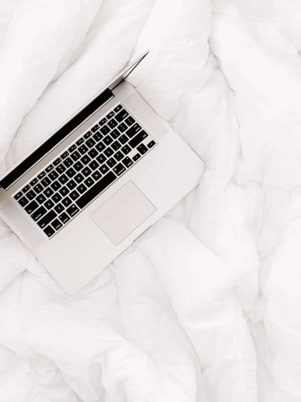 a laptop on a duvet
