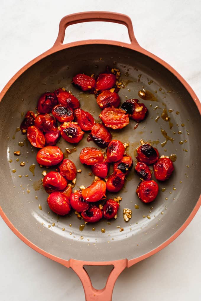 roasted cherry tomatoes and garlic in a pan