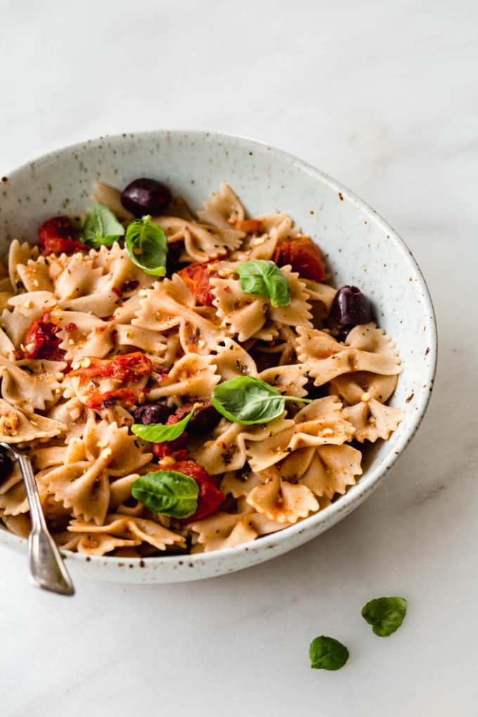 bow-tie pasta in a speckled white bowl