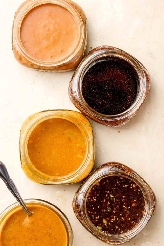 5 jars with marinades in them