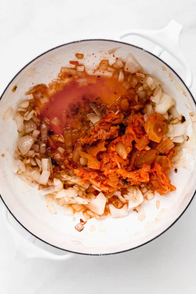 onions, garlic and kimchi in a pot