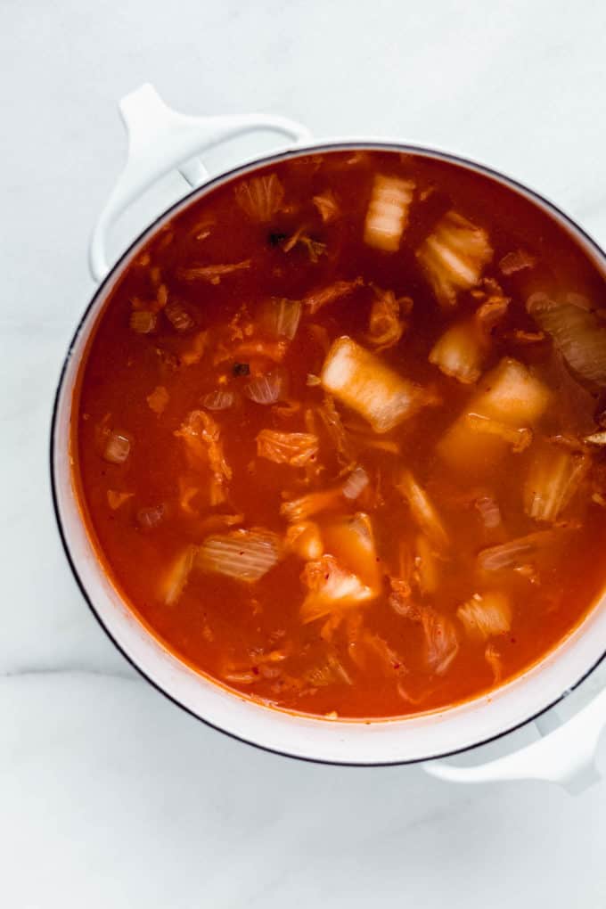 Korean Tofu Soup in a white pot on a marble board