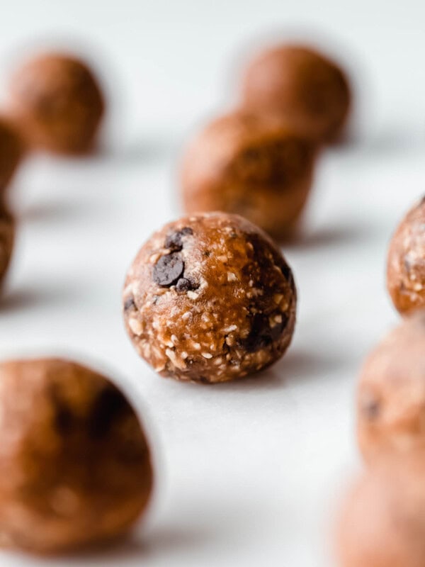 A peanut butter protein ball on a marble board