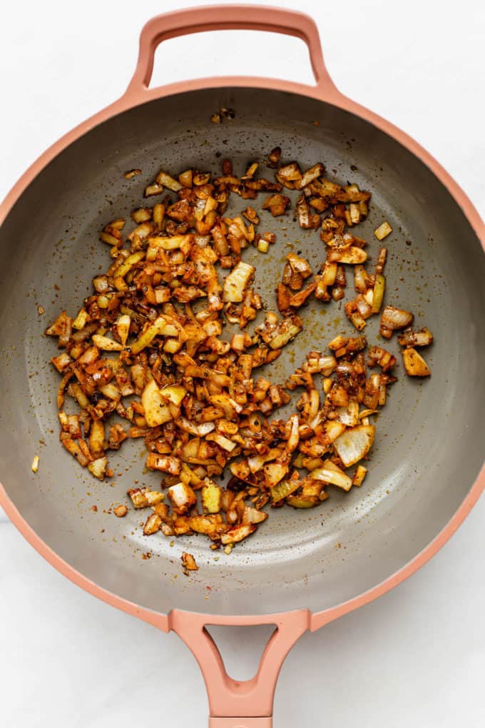 A pan with onions and garlic in it