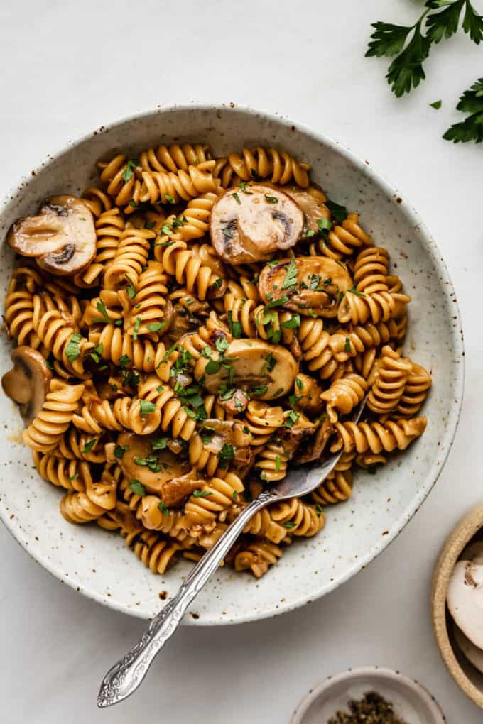 A bowl of mushroom stroganoff with a fork in it