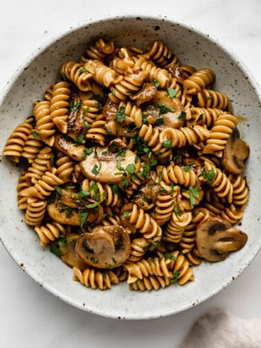 vegan mushroom stroganoff in a white speckled ceramic bowl