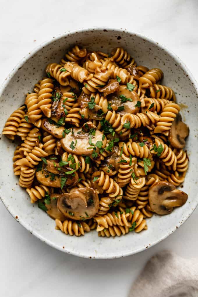 vegan mushroom stroganoff in a white speckled ceramic bowl
