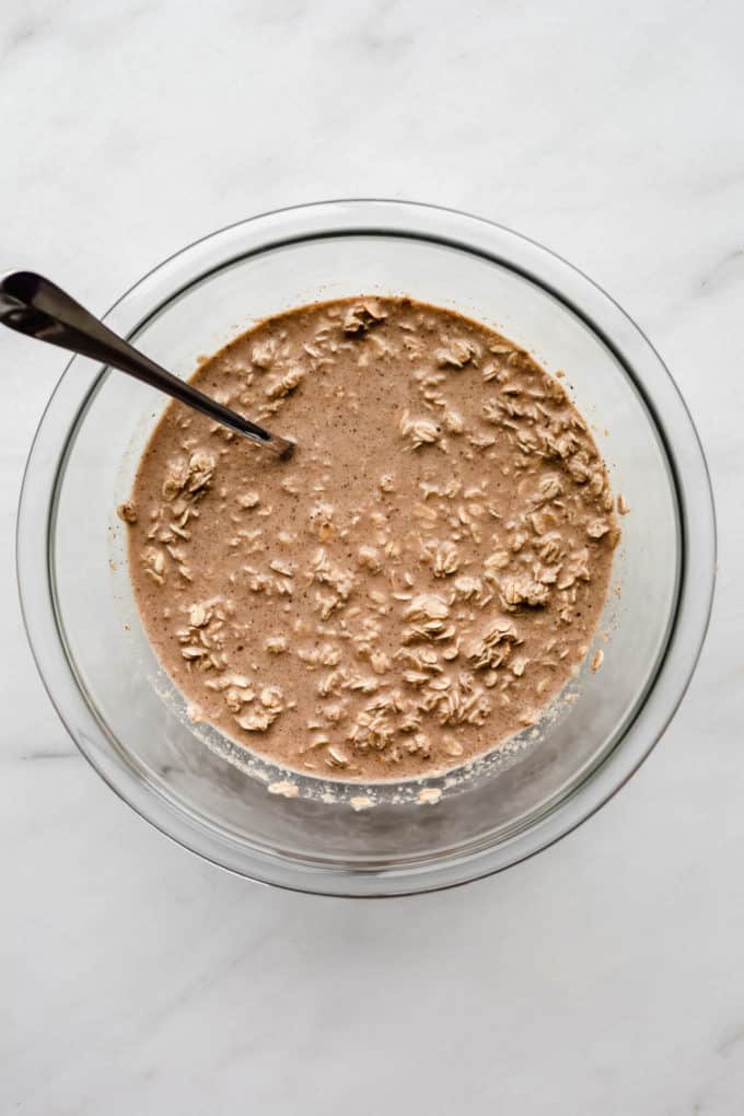 batter for baked oatmeal in a clear mixing bowl