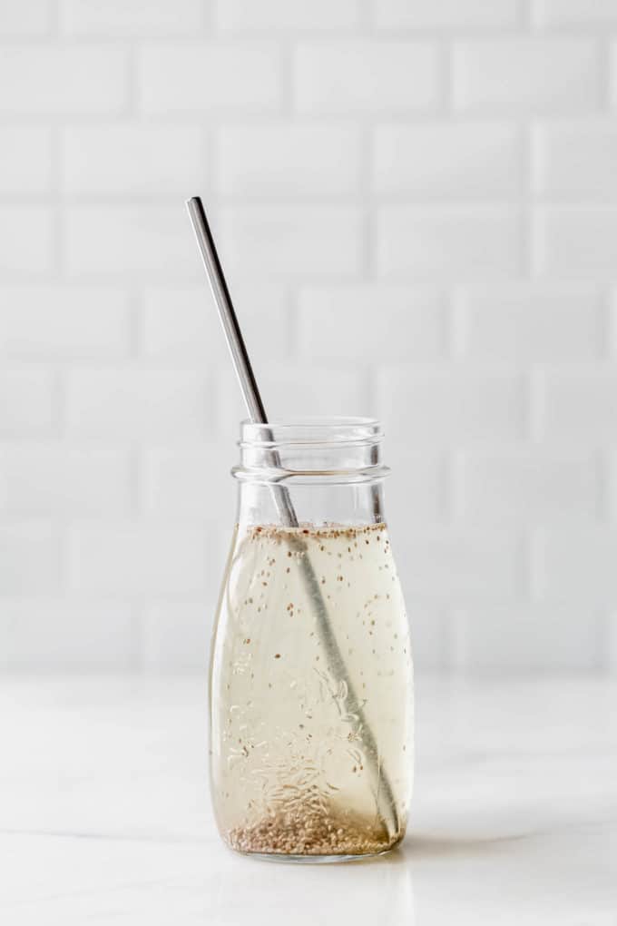 a chia seed drink in a jar with a metal straw