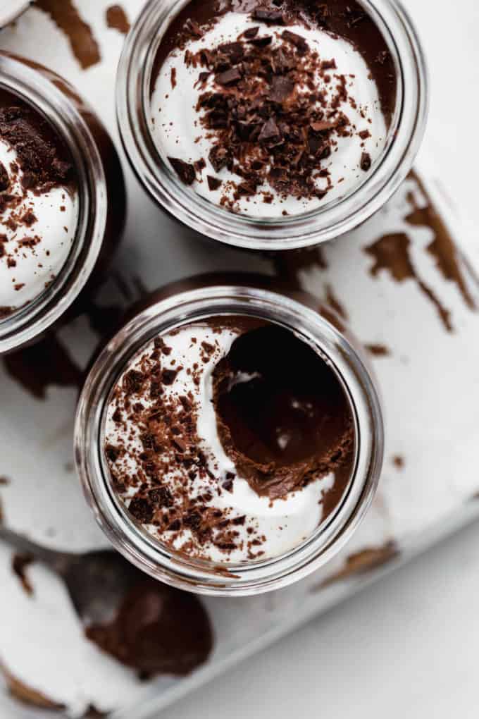 A top down view of chocolate pot de creme topped with yogurt