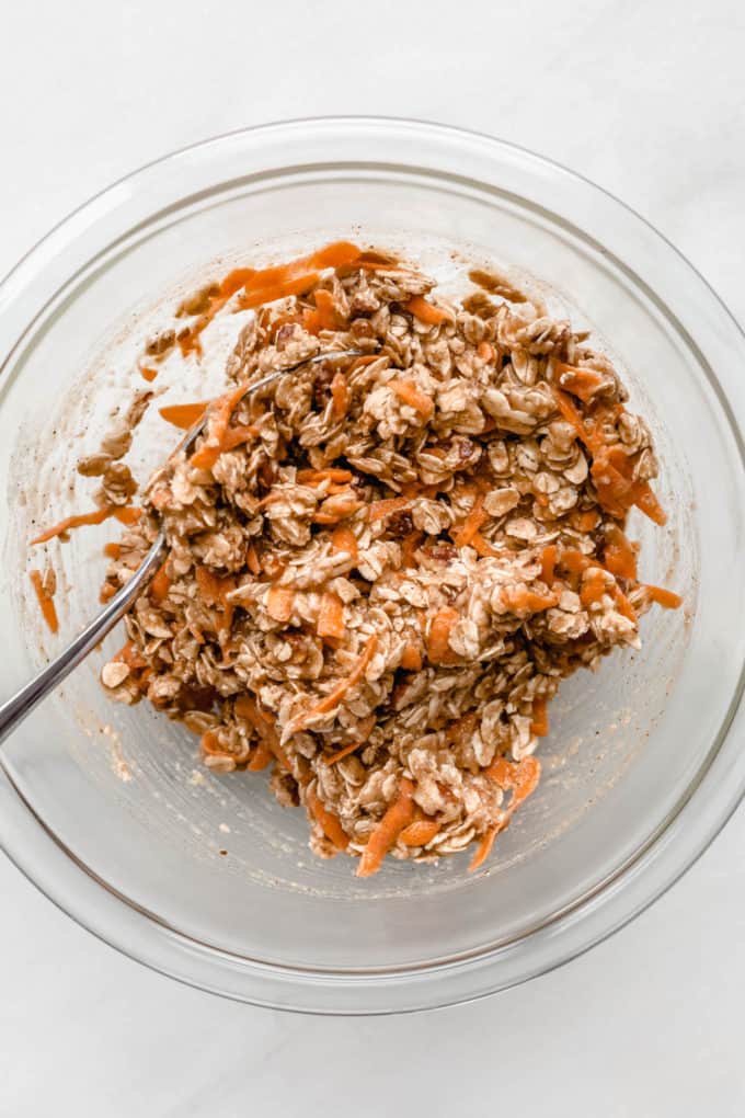 Carrot cake cookie dough in a clear mixing bowl