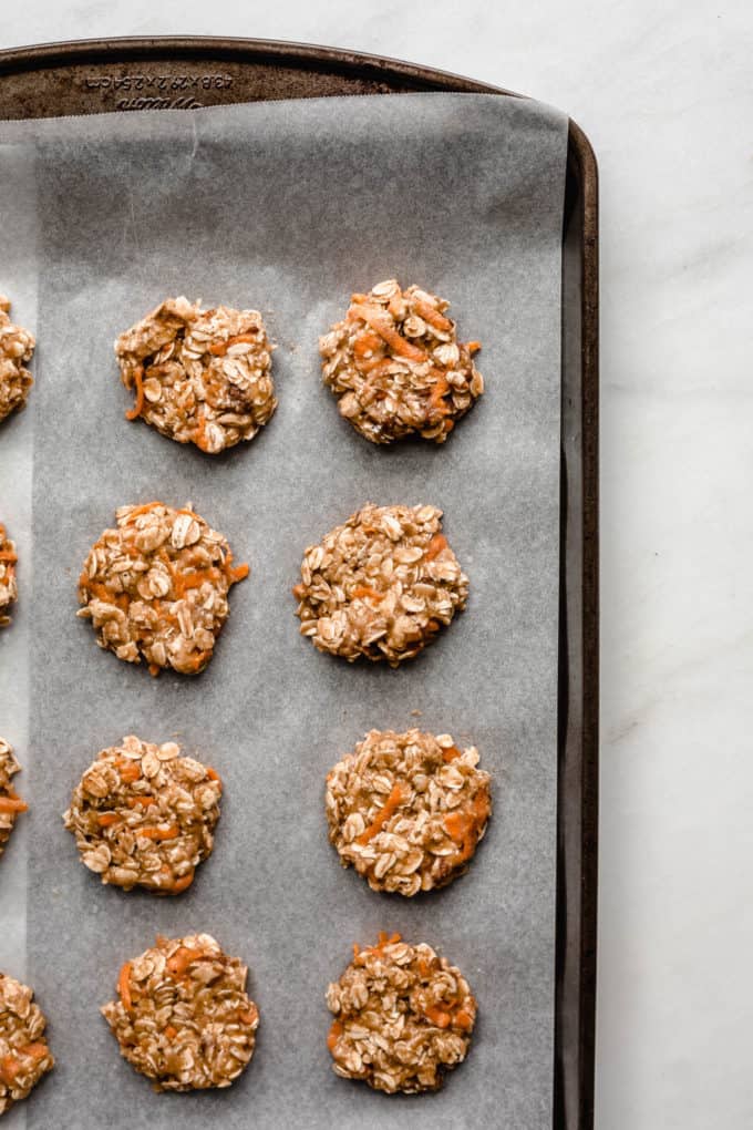 Unbaked carrot cake cookies on a baking sheet
