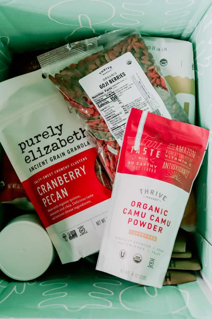 A box with camu camu, granola and goji berries in it