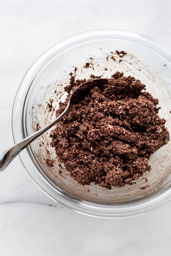 chocolate coconut macaroon dough in a clear mixing bowl