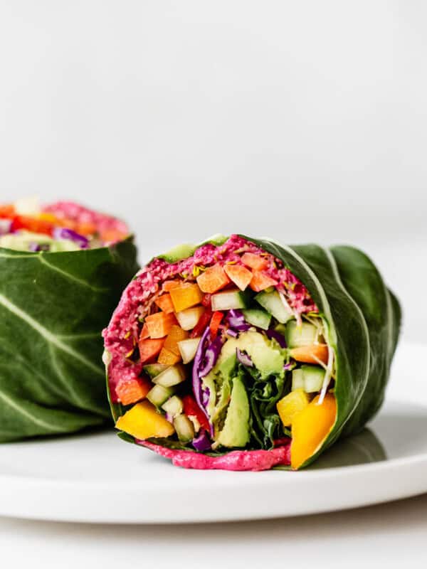 A rainbow collard green wrap on a white plate