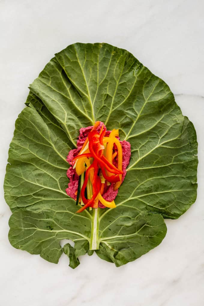A collard green leaf with peppers on it