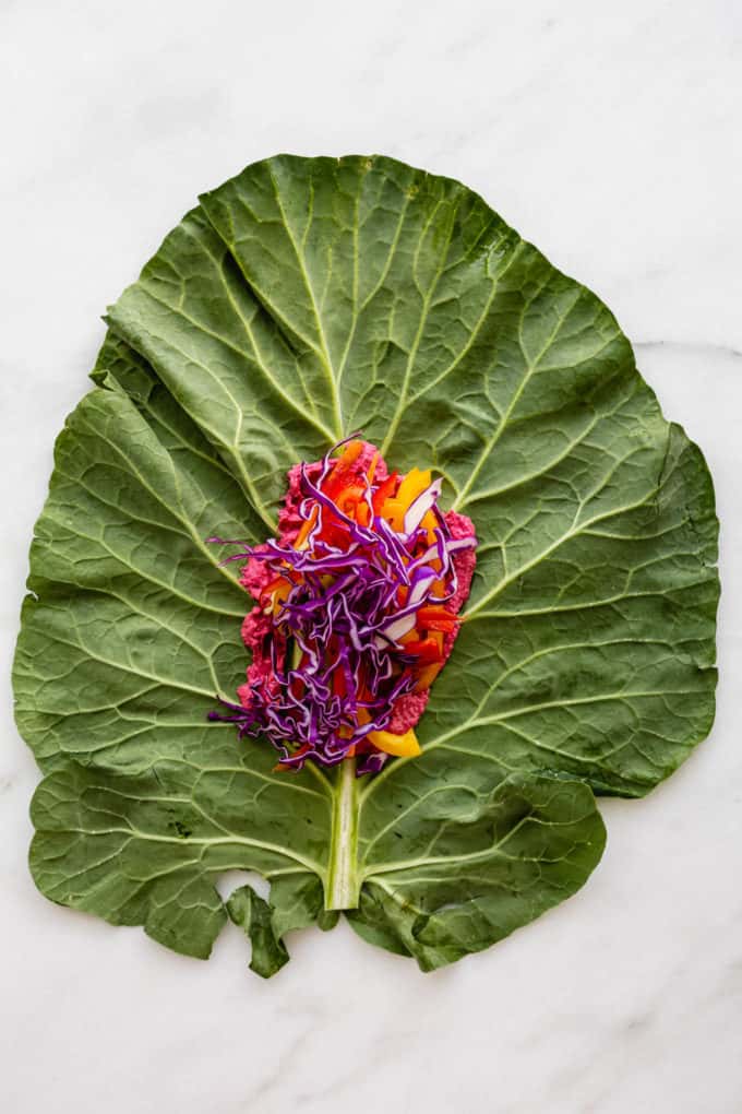 A collard green leaf with purple cabbage on it