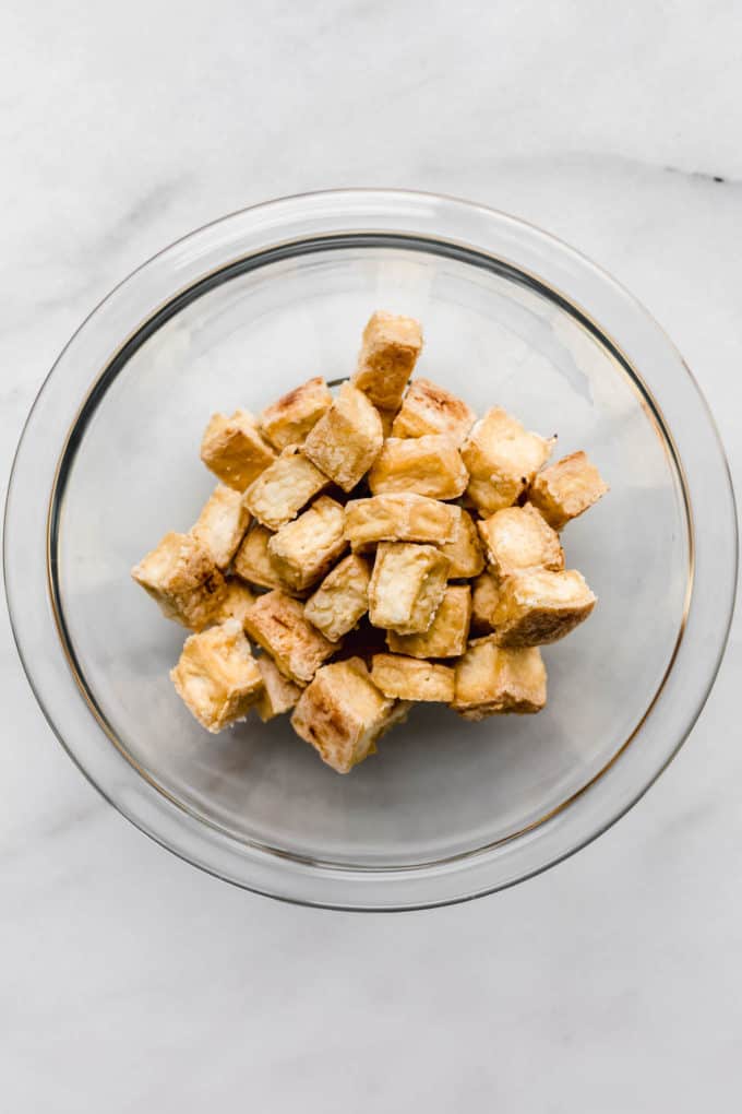 Baked crispy tofu in a clear bowl