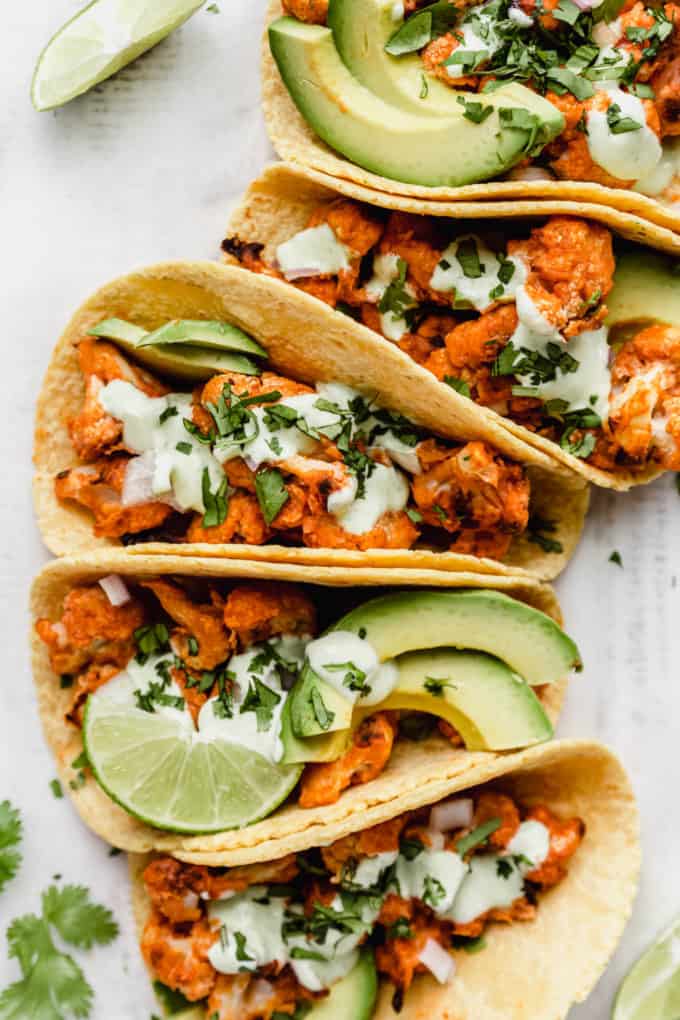 tacos filled with buffalo cauliflower and avocado