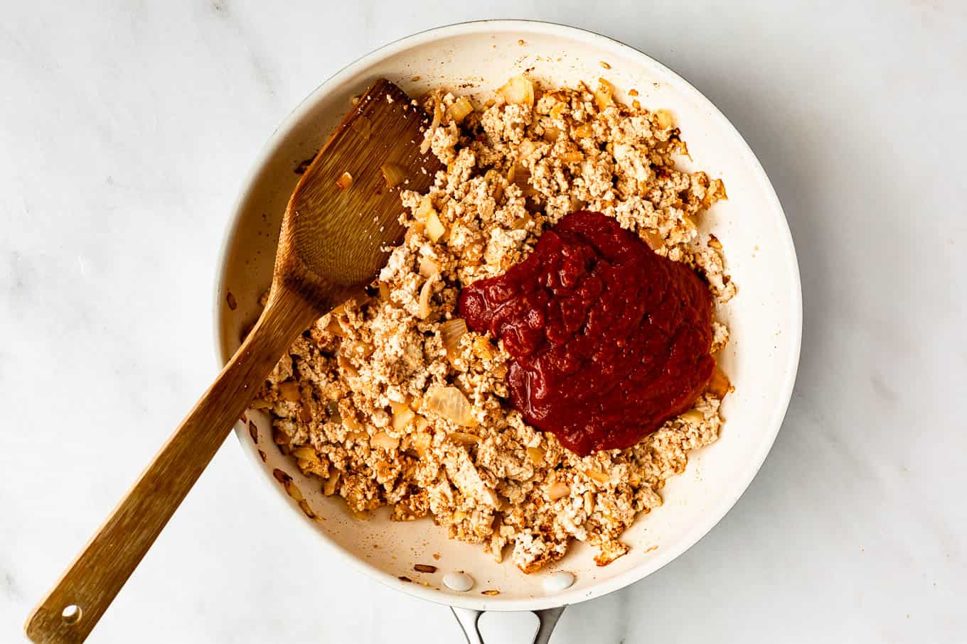 scrambled tofu and chipotle sauce in a white pan