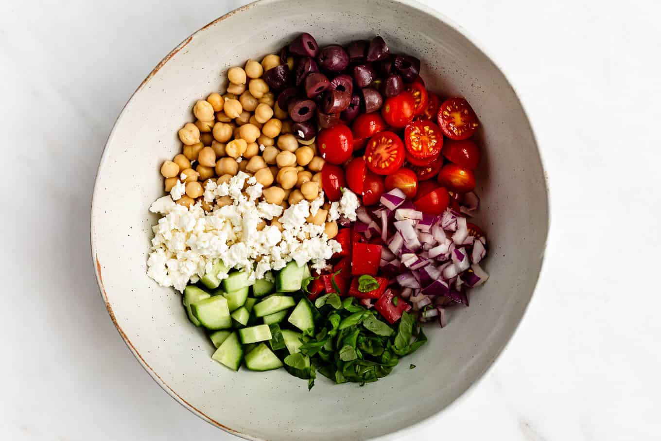 A bowl of vegetables, chickpeas and feta cheese