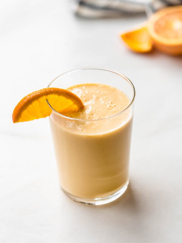 an orange creamsicle smoothie with an orange slice in it