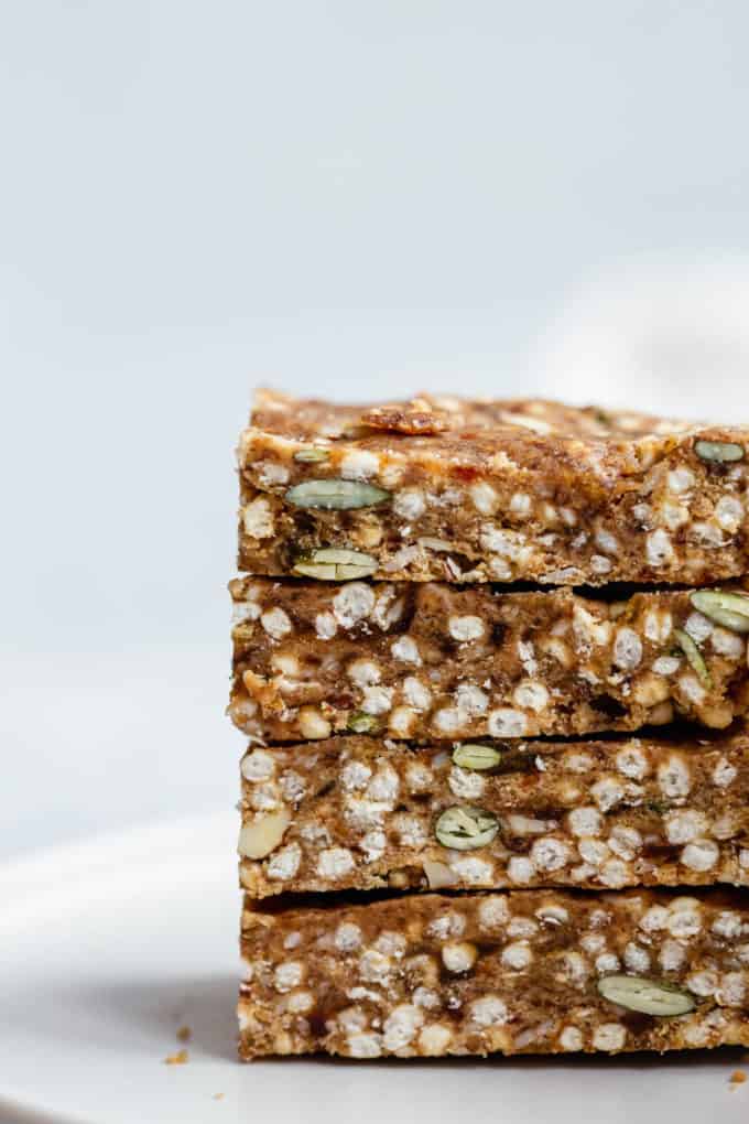 four puffed quinoa and nut bars stacked on top of each other