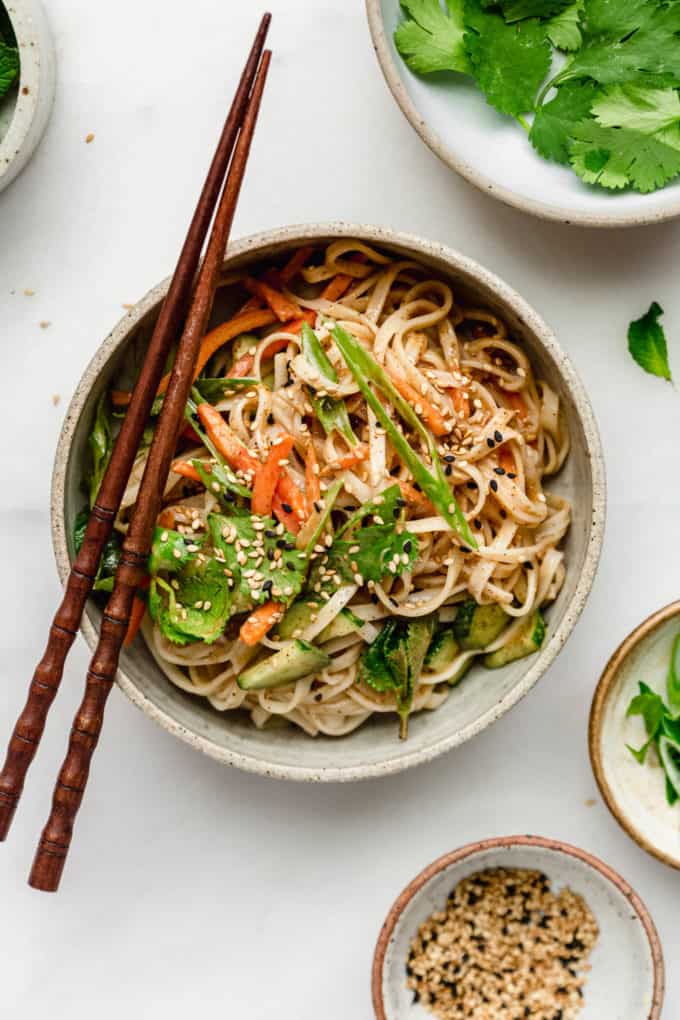 A spring roll noodle bowl tossed in almond butter sauce