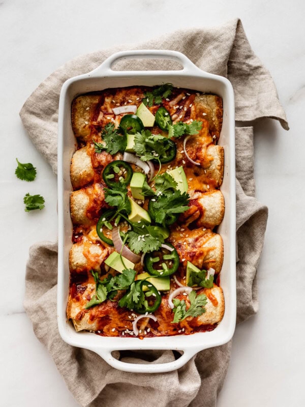 A dish of vegetable enchiladas on a beige napkin