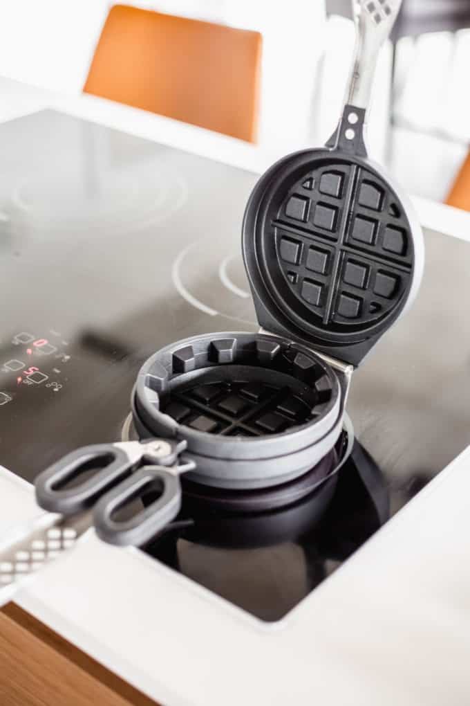an open waffle iron on the stove